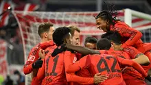 Pemain Bayern Munchen merayakan gol yang dicetak Harry Kane dalam laga pekan 11 Bundesliga Jerman 2024/2025, Sabtu (23/11/2024) dini hari WIB. Harry Kane mencetak hattrick dalam laga kontra Augsburg di Allianz Arena (LUKAS BARTH-TUTTAS / AFP)