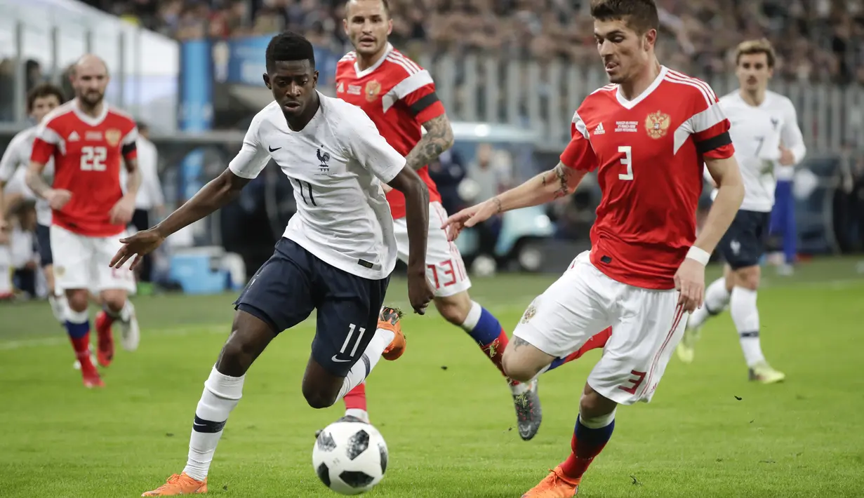 Gelandang Prancis, Ousmane Dembele, berusaha melewati bek Rusia Roman Neustadter, pada laga persahabatan di Stadion St Petersburg, Rusia, Selasa (27/3/2018). Rusia kalah 1-3 dari Prancis. (AP/Dmitri Lovetsky)