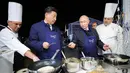 Presiden Rusia Vladimir Putin (dua kanan) berbincang dengan Presiden China Xi Jinping (kedua kiri) saat membuat pancake bersama di sela acara Eastern Economic Forum di Vladivostok, Rusia, Selasa (11/9). (Sergei Bobylev/TASS News Agency Pool Photo via AP)