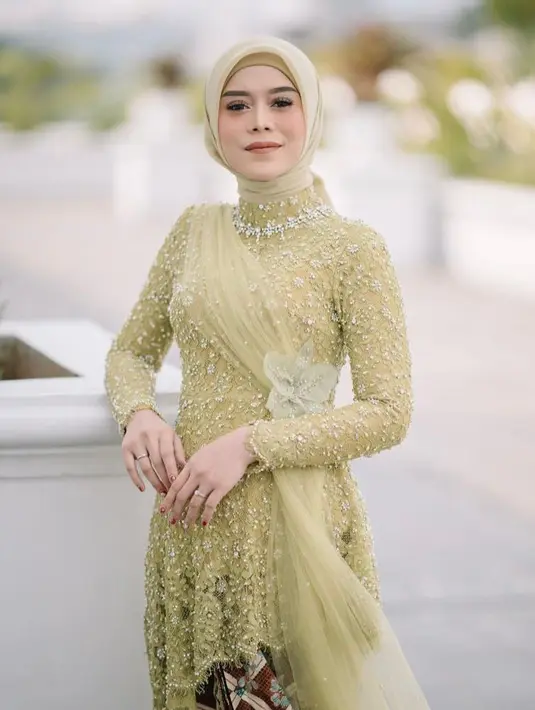 Di momen Langkahan Lesti Kejora pada 2021 lalu, penyanyi dangdut ini mengenakan kebaya hijau segar dengan ornamen berupa kain tulle dan bunga anggrek di pinggang yang menambah kesan apik. (Instagram/renzilazuardi).