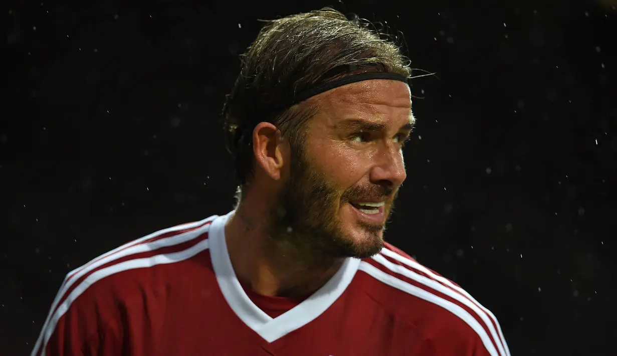 Kapten Great Britain & Ireland XI, David Beckham, tampil menghadapi World XI pada laga amal di Old Trafford, Inggris, Sabtu (14/11/2015) dini hari WIB. (AFP Photo/Paul Ellis)