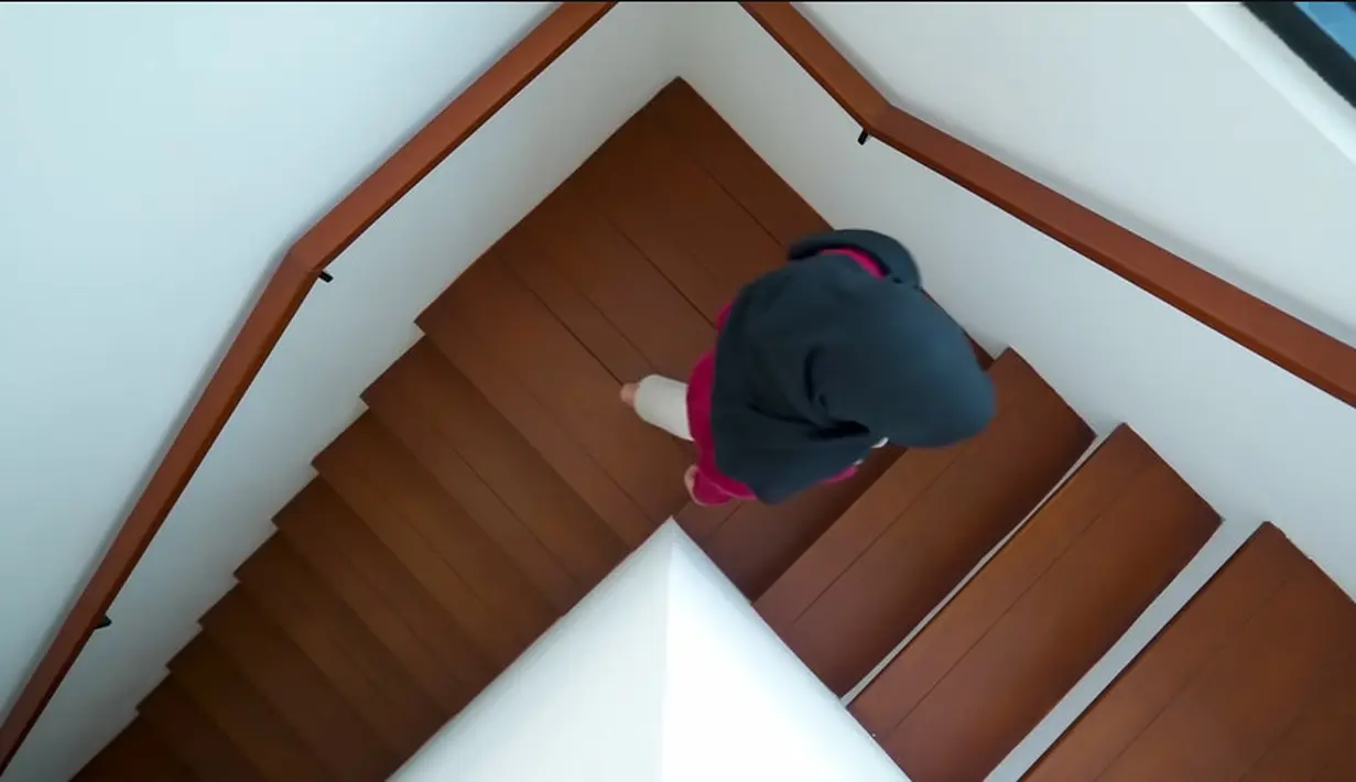 Tidak hanya dari luar yang terlihat dengan dominasi putih dan warna kayu, tapi juga saat masuk ke dalam. Tangga dengan ornamen kayu dan juga dinding warna putih. [Youtube/Arafah Rianti]