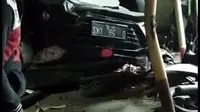 Kondisi mobil sigra nampak terbalik setelah oleng dan menabrak beberapa warga di Alfamarta, Otista, Garut, Jawa Barat (Liputan6.com/Jayadi Supriadin)