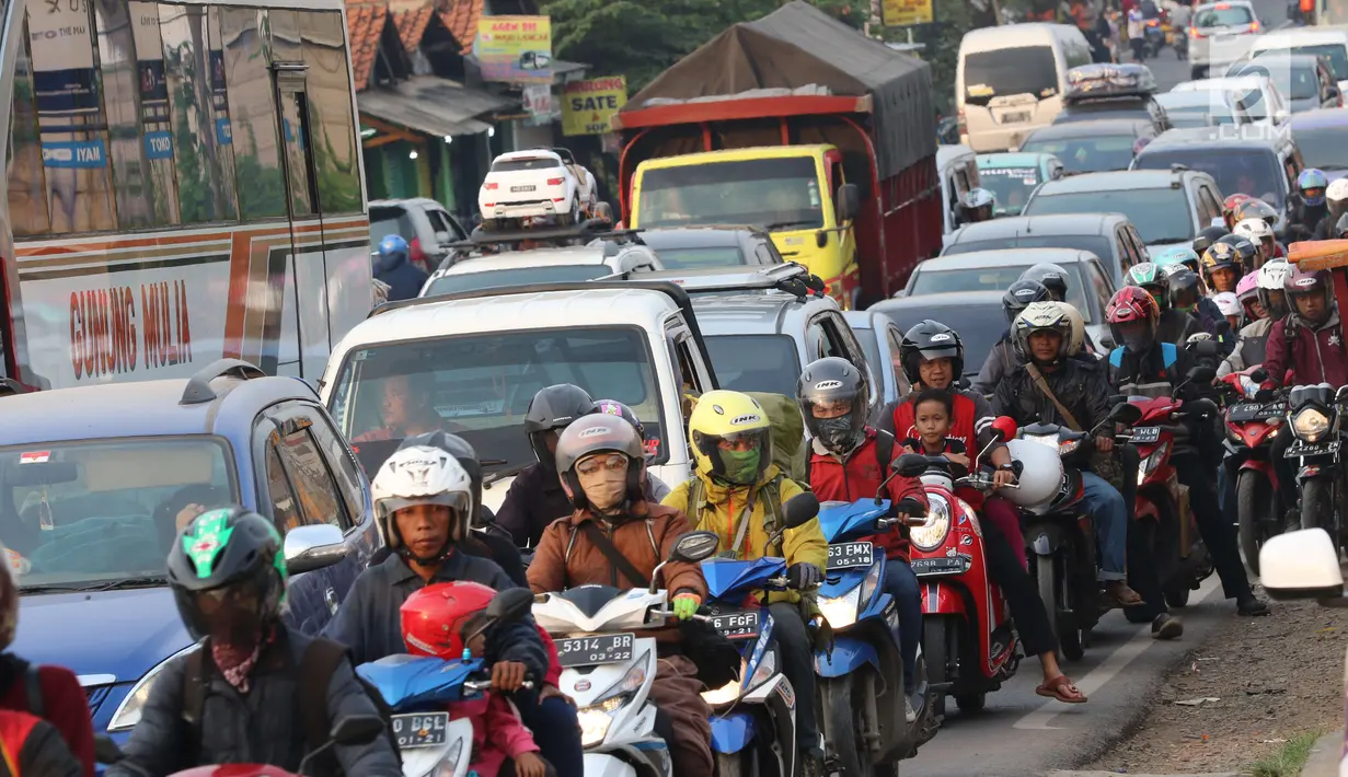 Sejumlah kendaraan mengarah Jakarta di Jalur Pantura Cikampek terjebak macet di jalan Jendral Sudirman,Cikampek,  Jawa Barat, Sabtu (7/1). (Liputan6.com/Helmi Afandi)