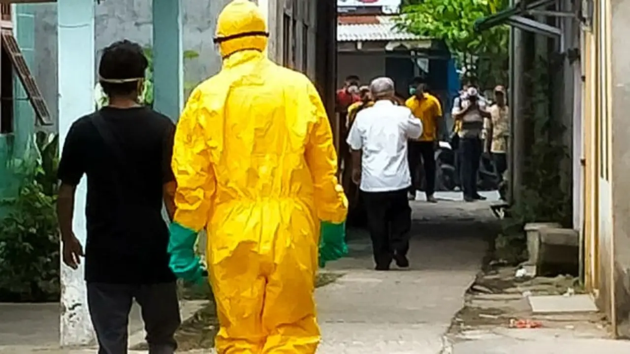 Tim medis menjemput salah satu warga terkonfirmasi Covid-19 untuk dirawat di rumah sakit.