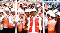 Presiden Joko Widodo (Jokowi) berfoto bersama para pekerja konstruksi di Stadion GBK, Jakarta, Kamis (19/10). Jokowi akan menyaksikan sertifikasi 9.700 tenaga kerja konstruksi di seluruh Indonesia secara serentak. (Liputan6.com/Angga Yuniar)