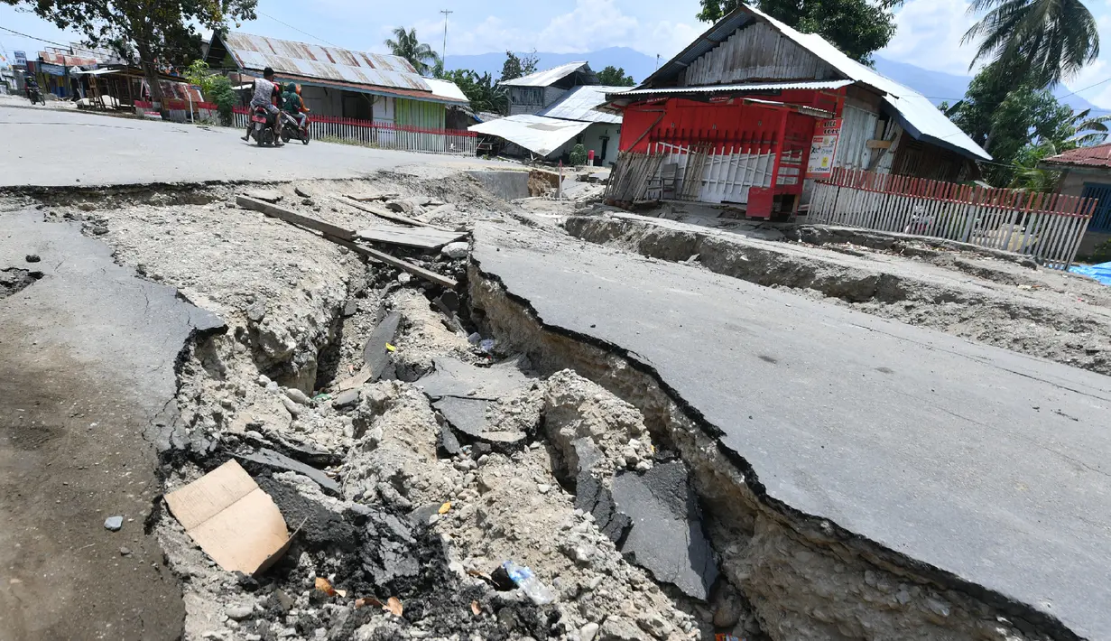 Jalanan rusak usai gempa dan tsunami melanda Kabupaten Sigi, Sulawesi Tengah, Kamis (4/10). Empat kecamatan terisolir yang dimaksud BNPB yaitu Lindu, Kolawi, Kolawi Selatan dan Titikor. (ADEK BERRY/AFP)