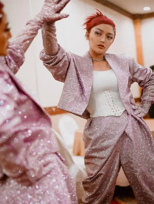 Sebagai penggemar bustier saat manggung, Siti Badriah juga tampil dengan crop top korset yang dipasangkan dengan setelan penuh glitter warna pink. [@sitibadriahh]