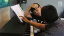 Seorang anak berkebutuhan khusus mendengarkan instruktur saat latihan piano di Daya Pelita Kasih Center, Pejaten, Jakarta, Kamis (24/5). Tempat pelatihan piano ini dipimpin oleh pianis Ananda Sukarlan. (Liputan6.com/Arya Manggala)