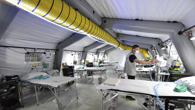 Petugas memeriksa peralatan medis ICU rumah sakit lapangan darurat Samaritan's Purse di Cremona, Italia, Jumat, 20 Maret 2020. Rumah sakit lapangan ini dibangun untuk merawat pasien virus corona COVID-19 yang terus melonjak. (Claudio Furlan/LaPresse via AP)