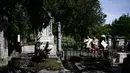 Turis mengunjungi pemakaman Pere Lachaise di Paris (22/7/2019). Pemakaman ini paling banyak didatangi wisatawan di dunia. Artis dan banyak tokoh terkenal dimakamkan di sini. (AFP Photo/Philippe Lopez)