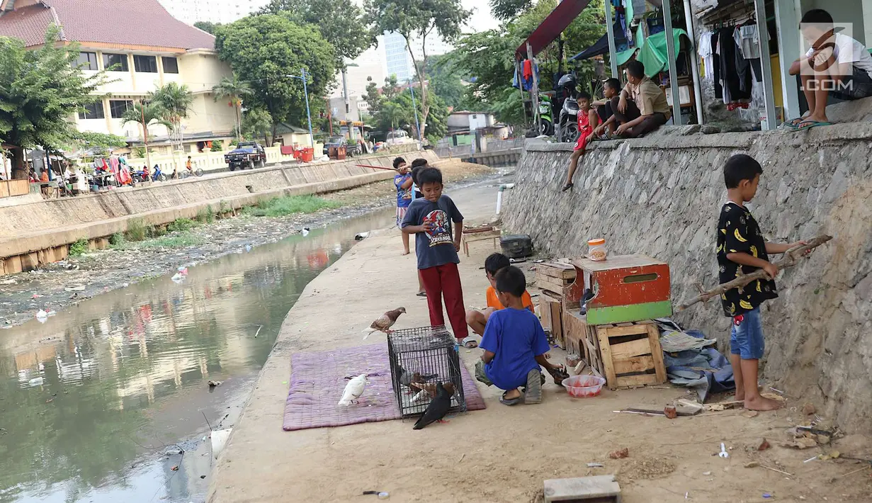 Suasana di bantaran anak Sungai Ciliwung, Jakarta, Rabu (6/6). Meskipun tidak layak sebagai tempat bermain, namun lokasi itu menjadi tempat bagi anak-anak di kawasan tersebut untuk menunggu waktu berbuka. (Liputan6.com/Immanuel Antonius)