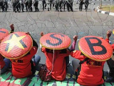 Buruh melakukan demo memperingati hari lahirnya organisasi buruh internasional World Federation of Trade Unions (WFTU) di Jakarta, Sabtu (3/10/2015).  Sejumlah PKL memanfaatkan demo buruh untuk meraup sedikit keuntungan. (Liputan6.com/Gempur M Surya)