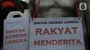 Buruh melakukan aksi unjuk rasa di depan gedung Kementerian Perdagangan, Jakarta Selasa (22/3/2022). Aksi menuntut Kementerian Perdagangan untuk menurunkan harga minyak goreng dan harga bahan pokok di pasar tradisional serta mendesak Menteri Perdagangan diganti. (merdeka.com/Imam Buhori)
