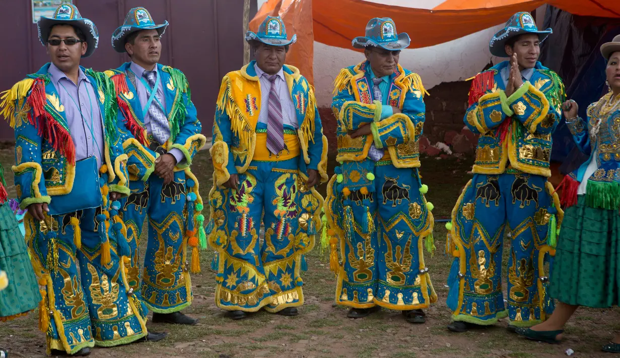 Sejumlah warga mengenakan kostum bersiap mengikuti karnaval Anata Andina (Andean karnaval) di Caquiaviri, Bolivia, Selasa (17/1). Karnaval tersebut dimeriahkan dengan penampilan musik seperti orkestra dan band. (AP Photo/Juan Karita)