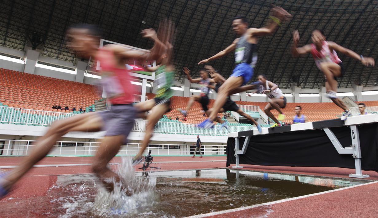 Para pelari melompat saat tampil pada Kejurnas Atletik 2019 nomor 3.000 meter steeplechase senior di Stadion Pakansari, Bogor, Rabu (8/8). Kejurnas Atletik berlangsung dari 3-7 Agustus. (Bola.com/Vitalis Yogi Trisna)