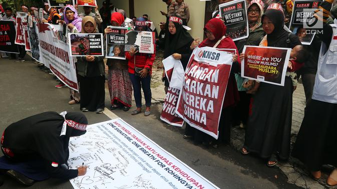 Komite Nasional Solidaritas Rohingya mengumpulkan tanda tangan saat menggelar aksi di depan Kantor Duta Besar Myanmar, Jakarta, Rabu (5/12). Massa membawa sejumlah poster yang berisi kecaman terhadap pemerintah Myanmar. (Liputan6.com/JohanTallo)
