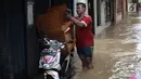 Warga beraktivitas saat banjir di Jalan Kebon Pala, Kampung Melayu, Jatinegara, Jakarta Timur, Rabu (7/2). Setelah sempat surut, banjir kembali merendam permukiman warga dengan ketinggian air mencapai sekitar 170 cm. (Liputan6.com/Arya Manggala)