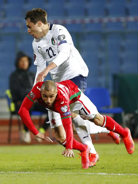 Pemain Bulgaria Momchil Tsvetanov (depan) memperebutkan bola dengan pemain Italia Federico Chiesa pada pertandingan Grup C kualifikasi Piala Dunia 2022 di Stadion Vassil Levski, Sofia, Bulgaria, Minggu (28/3/2021). Italia menang dengan skor akhir 2-0. (AP Photo/Tony Uzunov)