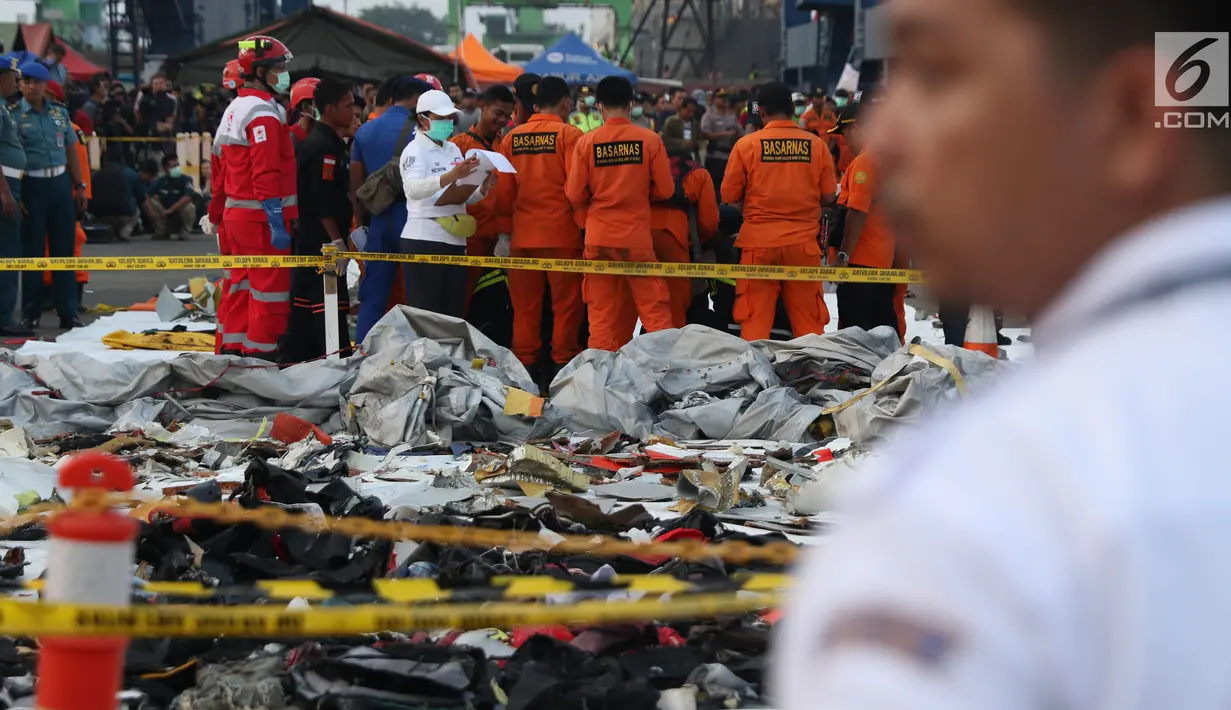 Personil SAR Gabungan mengidentifikasi isi kantong jenasah yang diturunkan dari KRI Torani di Pelabuhan JICT 2, Jakarta, Kamis (1/11). Pesawat Lion Air PK LQP JT 610 jatuh di perairan Karawang pada Senin (29/10) lalu. (Liputan6.com/Helmi Fithriansyah)