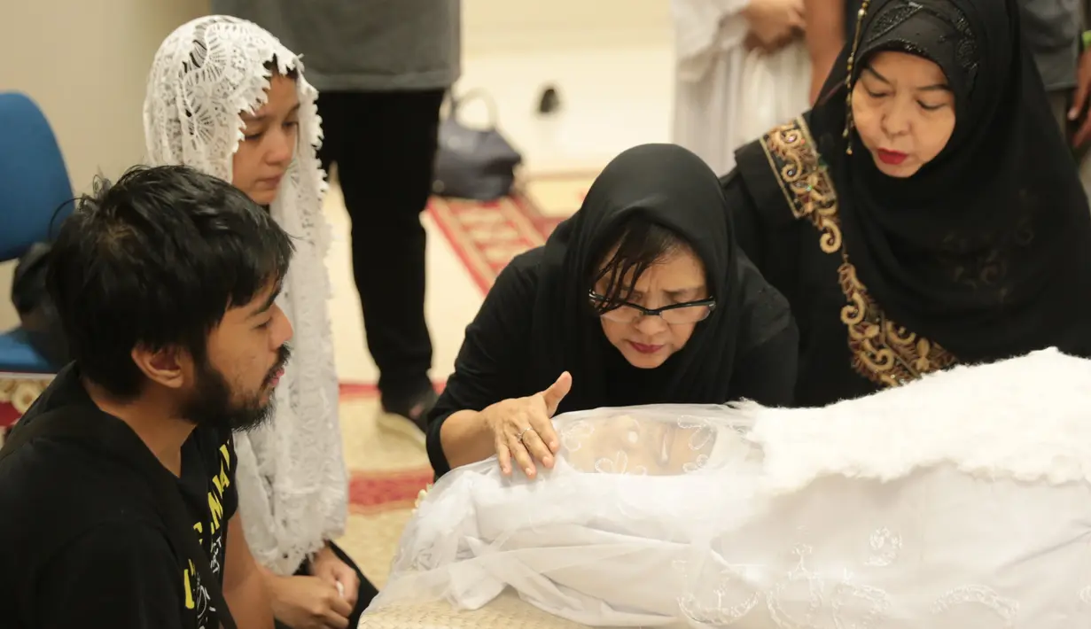 Gurat kesedihan dari pihak keluarga begitu terlihat dan terus memperhatikan jenazah yang terbujur kaku didepannya. Sebelum ditutup kain putih, pihak keluarga satu persatu mencium untuk terakhir kalinya. (Adrian Putra/Bintang.com)
