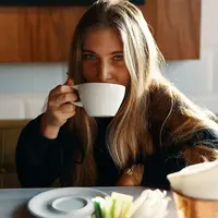 Ilustrasi menikmati kopi (Photo by Gian Cescon on Unsplash)