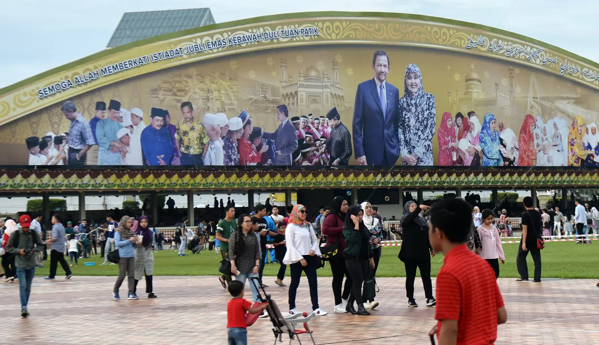 Warga tiba di Stasiun Kereta Brunei Darussalam Sultan Hassanal Bolkiah untuk menyaksikan prosesi Golden Jubilee yang diarak dengan kereta kerajaan Sultan Hassanal Bolkiah dan Ratu Saleha Brunei di Bandar Seri Begawan (5/10). (AFP PHOTO / Roslan Rahman)