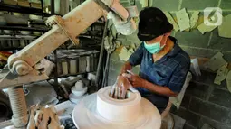 Perajin menyelesaikan pembuatan keramik secara handmade di Pekunden Pottery, Bojongsari, Depok, Jawa Barat, Rabu  (22/9/2021). Dalam sebulan, Pekunden Pottery mampu memproduksi 300-400 buah keramik sesuai pesanan khusus, baik dari hotel maupun kafe tertentu. (merdeka.com/Arie Basuki)