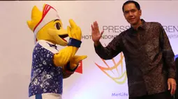 Ketua Umum PBSI, Gita Wirjawan, melakukan tos dengan maskot BIOSSP 2016 saat peluncuran Indonesia Open 2016 di Hotel Kempinski, Jakarta, Rabu (11/5/2016). (Bola.com/Nicklas Hanoatubun)