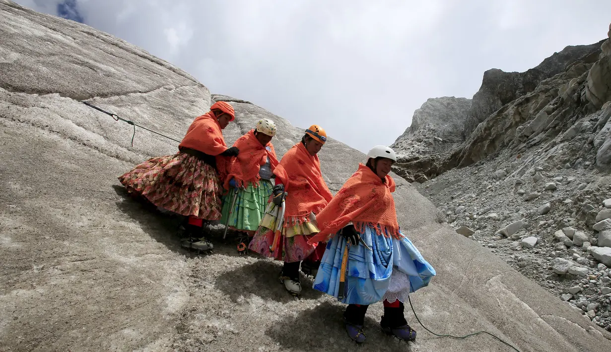 Perempuan suku Aymara mendaki Gunung Huayna Potosi, Bolivia (6/4). Sebanyak 12 perempuan Suku Aymara rata-rata berusia 42-50 tahun ini berhasil menaklukkan puncak Gunung Huayna Potosi dan Illimani. (REUTERS/David Mercado)