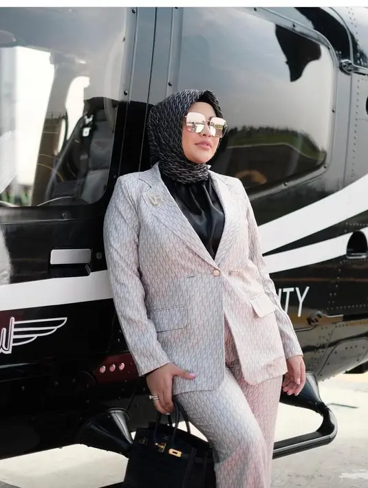 Seperti potret ini, Aurel tampil modis dengan gaya formal. Ia terlihat mengenakan setelan blazer warna putih dipadu hijab dan inner serba hitam.  @aurelie.hermansyah.