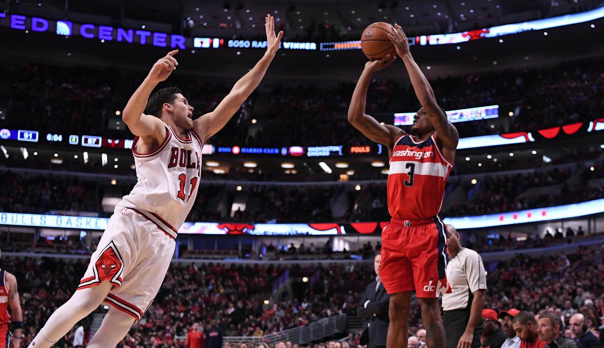 Pemain Washington Wizards, KBradley Beal  (kiri) mencoba menghadang tembakan pemain Chicago Bulls Doug McDermott pada laga NBA basketball game di United Center, Chicago, (21/12/2016).  Wizards menang 107-97. (Reuters/Mike DiNovo-USA TODAY Sports)