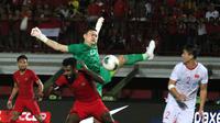 Bek Timnas Indonesia, Yanto Basna, berebut bola dengan kiper Timnas Vietnam, Dang Van Lam, pada laga Kualifikasi Piala Dunia 2022 di Stadion Kapten I Wayan Dipta, Bali, Selasa (15/10). Indonesia kalah 1-3 dari Vietnam. (AFP/Aditya Wany)