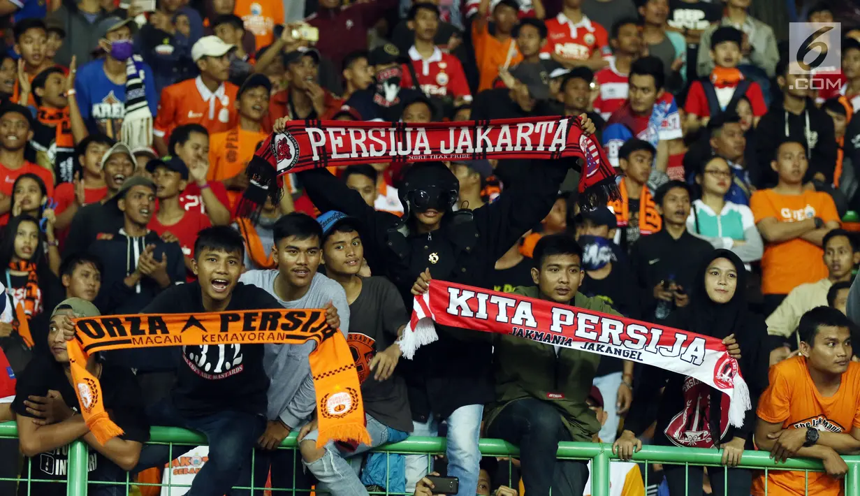 Suporter tim Macan Kemayoran membentangkan syal saat menyaksikan kemenangan Persija atas Arema FC dilanjutan Liga 1 Indonesia di Stadion Patriot Candrabhaga, Bekasi, Jumat (2/6). Persija unggul 2-0 atas Arema FC. (Liputan6.com/Helmi Fithriansyah)