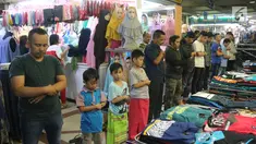 Sejumlah umat muslim melaksanakan salat jumat pada bulan Ramadan di antara pakaian yang dijajakan di kios Pasar Tanah Abang, Jakarta, Jumat (25/5). Jemaah terpaksa melakukan salat di lorong kios karena terbatasnya ruang masjid (Liputan6.com/Arya Manggala)