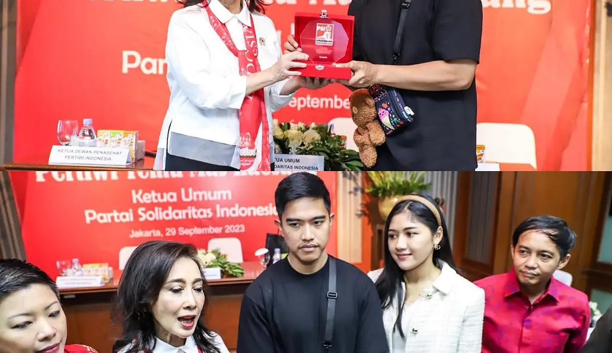 Menyambangi kantor organ Relawan Jokowi, Erina tampak elegan dengan ansambel serba putihnya yang dipadukan bando warna coklat.