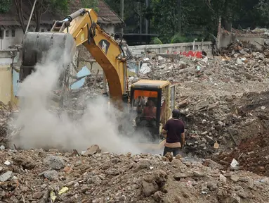 Alat berat dikerahkan untuk menyelesaikan proyek pembangunan Penampungan Sementara Pedagang Pasar Rumput, Jakarta, Selasa (19/4) Ditargetkan, Pembangunan TPS rampung Juni mendatang. (Liputan6.com/ Gempur M Surya)