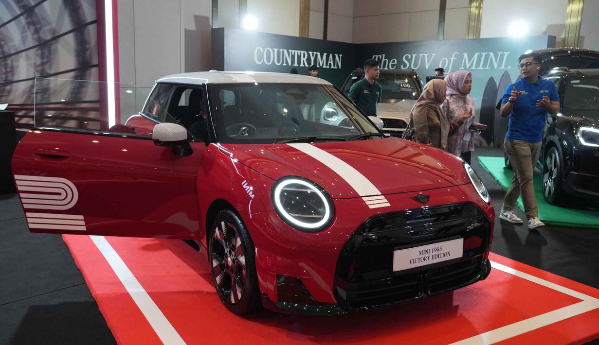 Orang-orang melihat kendaraan listrik MINI 1965 Victory Edition selama acara peluncurannya di Jakarta, Jumat 17 April 2026. MINI Indonesia secara resmi meluncurkan model edisi terbatas MINI 1965 Victory Edition. (AP Photo/Tatan Syuflana)