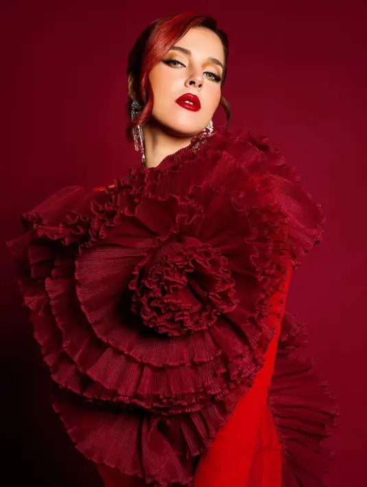 Tasya Farasya tampil dramatis dengan outfit megah. Kostum serba merah dipadu makeup bold dengan warna lipstik merah merona dan rambut merahnya yang ditata dengan gaya elegance look. Foto: Instagram.
