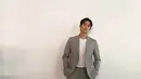 Office look Kim Soo Hyun dengan kaus putih ditumpuknya mengenakan setelan blazer dan celana panjang abu-abu. [Foto: Instagram/soohyun_k216]