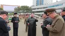 Pemimpin Korea Utara Kim Jong Un (tengah) berbincang dengan para pejabat saat memeriksa lokasi kompleks perumahan 10.000-flat yang sedang dibangun di Pyongyang (16/3/2022). Kim telah menghadiri upacara peletakan batu pertama situs tersebut Maret lalu. (AFP/STR/KCNA Via KNS)