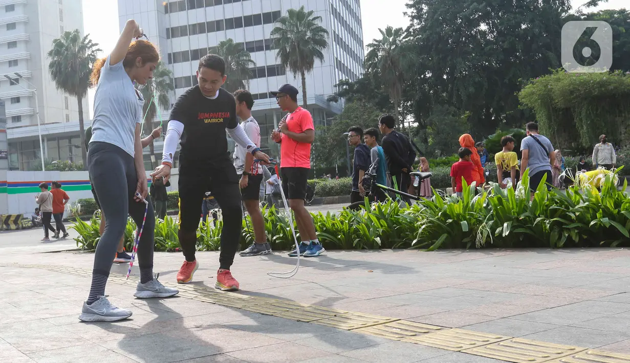 Warga sedang mencoba olahraga lompat tali di kawasan bundaran Hotel Indonesia, Jakarta, Minggu (12/6/2022). Komunitas Jump Rode Indonesia mensosialisasikan olahraga lompat tali beberapa variasi gerakan ya bisa di pelajari seperti gerakan satu kaki. (Liputan6.com/Herman Zakharia)