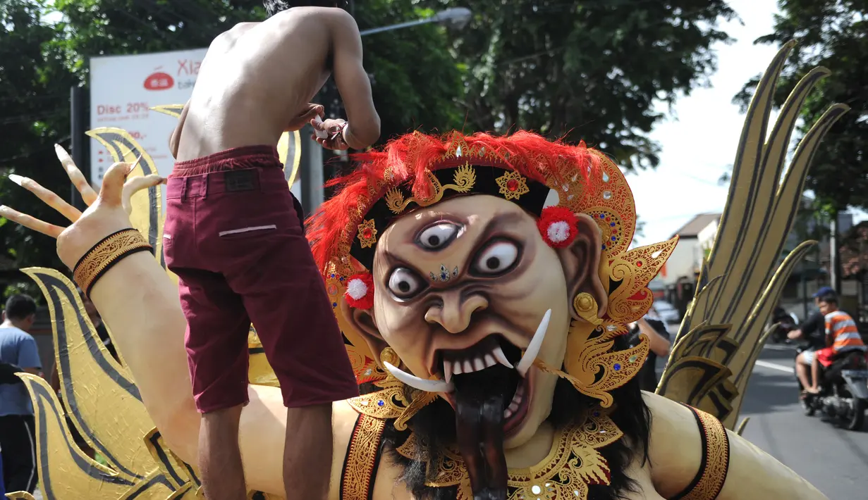 Umat Hindu Bali menyiapkan Ogoh-Ogoh sebelum parade hari Nyepi di Denpasar, Bali, Senin (27/3). Umat Hindu di Bali akan merayakan hari raya Nyepi Tahun Baru Saka 1939 pada tanggal 28 Maret 2017. (AFP Photo / Sonny Tumbelaka) 