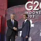 Perdana Menteri Singapura Lee Hsien Loong menyapa Presiden Indonesia Joko Widodo atau Jokowi yang menyambutnya pada hari pertama Konferensi Tingkat Tinggi (KTT) G20 di Nusa Dua, Bali, Selasa (15/11/2022) pagi. Setidaknya total 17 kepala negara G20 akan menghadiri KTT dua hari ini. (Kevin Lamarque/Pool via AP)