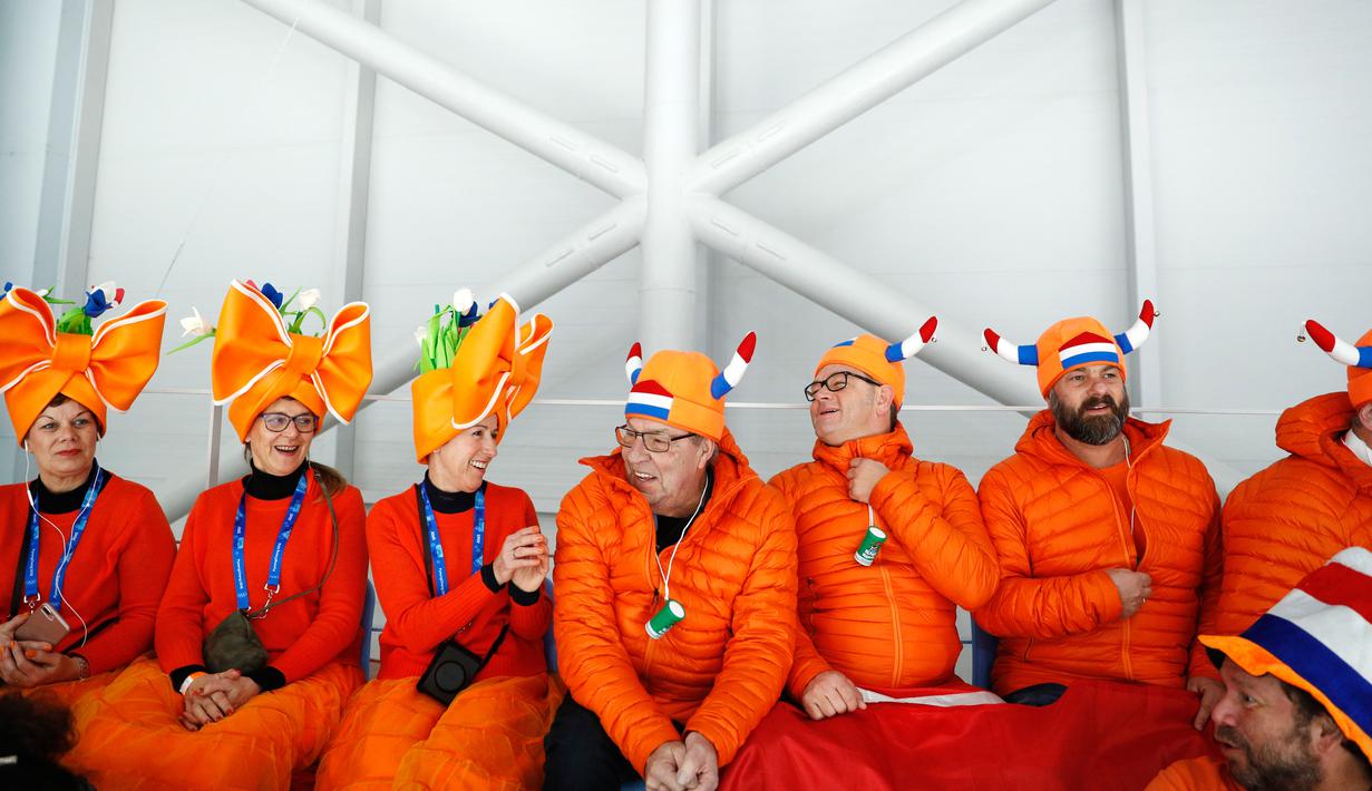 Penonton mengenakan atribut kepala unik saat menunggu dimulainya balapan speed skater 1.500 meter pada Olimpiade Musim Dingin 2018 di Gangneung, Korea Selatan, Selasa (13/2). Ada 92 negara peserta yang mengikuti ajang tersebut. (AP/John Locher)