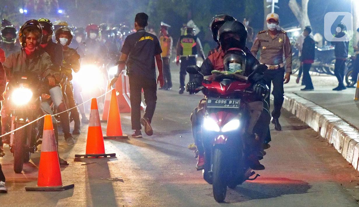 Pemudik motor melintas di posko penyekatan mudik di Kedungwaringin, Kabupaten Bekasi, Jawa Barat, Selasa (11/5/2021) dini hari. Diskresi terhadap pemudik motor dilakukan sebagai langkah pencegahan mengurangi kerumunan. (Liputan6.com/Herman Zakharia)