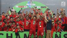 Kapten tim Persija, Ismed Sofyan dan Bambang Pamungkas mengangkat piala Liga 1 Indonesia usai menumbangkan Mitra Kukar di Stadion GBK, Jakarta, Minggu (9/12). Persija meraih juara Liga 1 Indonesia 2018 dengan 62 poin. (Liputan6.com/Helmi Fithriansyah)