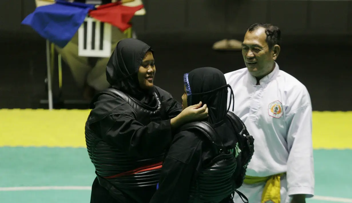 Pesilat memeriksa lawanya sebelum beraksi pada ajang Kejurnas Pagar Nusa di Padepokan Pencak Silat TMII, Jakarta, Minggu (6/1/2020). Sebanyak 487 pesilat dari seluruh Indonesia berpartisipasi dalam Kejurnas sekaligus Harlah ke-34 Pagar Nusa. (Bola.com/M Iqbal Ichsan)