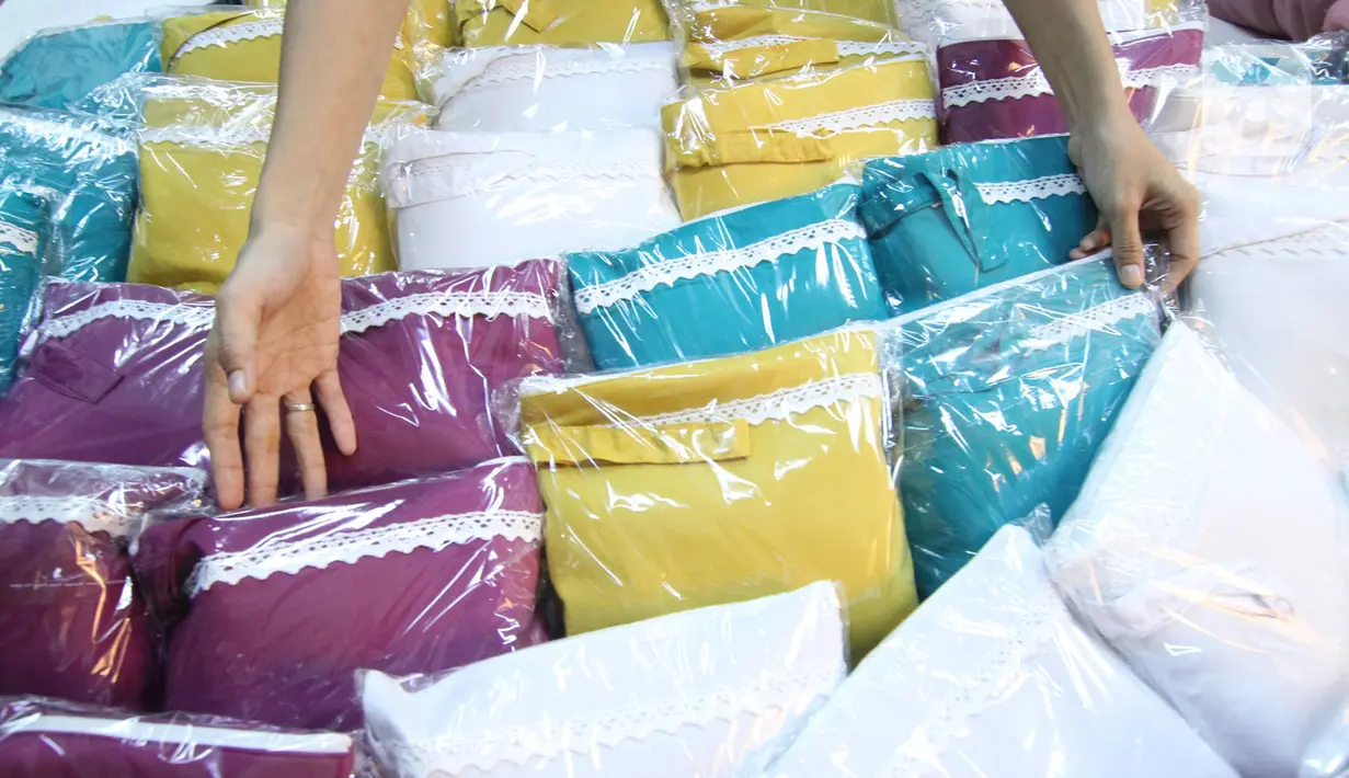 Pekerja menata mukena yang telah selesai di Pinang, Kota Tangerang, Banten, Kamis (22/4/2021). Di bulan Ramadhan, produksi mukena di tempat tersebut meningkat 50 persen, dari 350 buah menjadi 700 buah per minggu dan dijual dengan harga Rp250 ribu hingga Rp500 ribu. (Liputan6.com/Angga Yuniar)