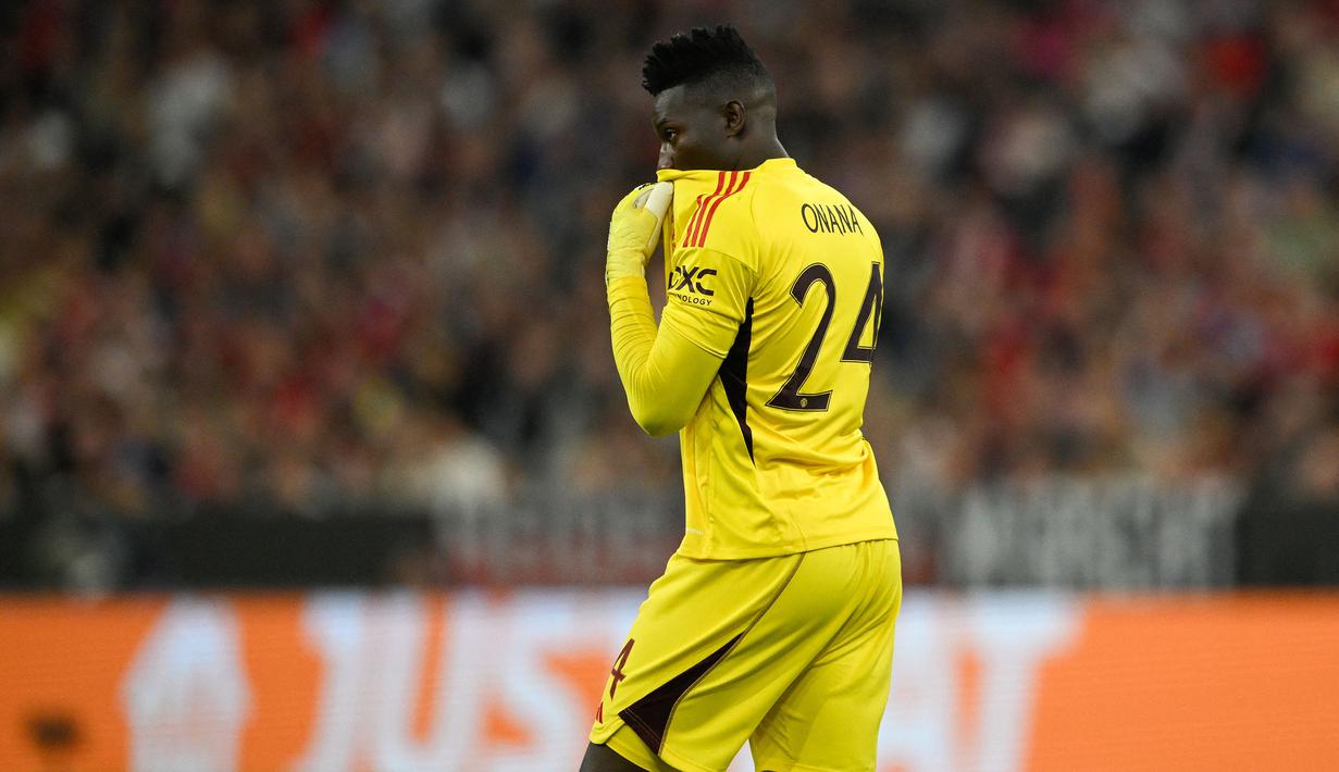 Reaksi kecewa kiper Manchester United, Andre Onana setelah kebobolan gol pertama melalui tendangan gelandang Bayern Munchen, Leroy Sane pada laga matchday pertama Grup A Liga Champions 2023/2024 di Allianz Arena, Munich, Kamis (21/9/2023) dini hari WIB. (AFP/Tobias Schwarz)